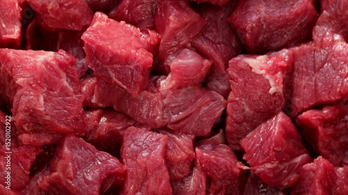 raw beef cubes turning in slow rotation, showcasing rich red color and natural texture, ideal for food preparation visuals, recipes, and protein nutrition themes