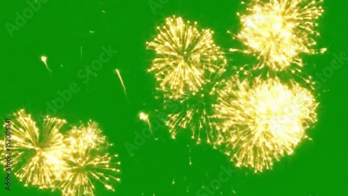 Golden fireworks exploding on a green screen background for compositing