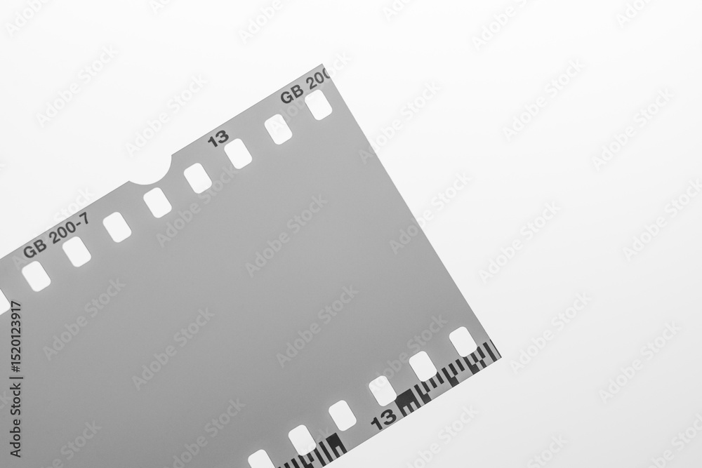 Fototapeta premium Blank monochrome 35mm Film Strip with Frame Number 13 and Code on White Background
