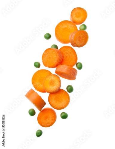 Falling carrot slice and green peas vegetales