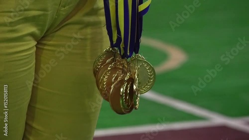 The girl holds many medals close up