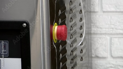 Red button of the vacuum machine close up