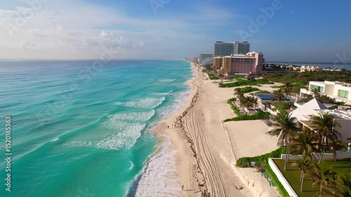 Breathtaking Aerial Drone View of Cancun's Iconic Hotel Zone with Turquoise Waters, White Sand Beaches, Luxury Resorts, and Palm-Lined Coastline on a Bright Sunny Summer Day
