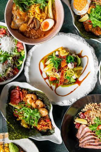 Wallpaper Mural A vibrant assortment of gourmet dishes including fresh salads, ramen, seafood, and meat, beautifully plated with colorful ingredients, showcasing culinary artistry and appetizing presentation Torontodigital.ca