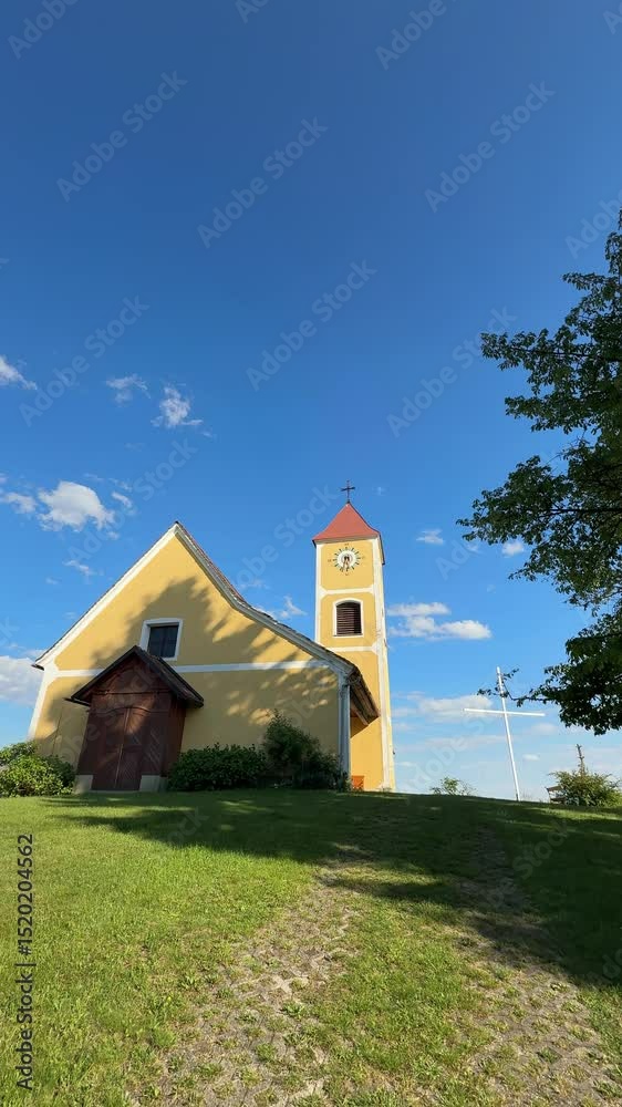 romantic church on hill with white cross in Austria romantic church on hill with white cross in Austria