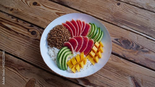 Colorful fruit platter with rice and grains served on a wooden table for a healthy meal