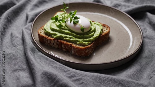Enjoying vibrant avocado toast with a perfectly poached egg and fresh microgreens for a satisfying breakfast meal