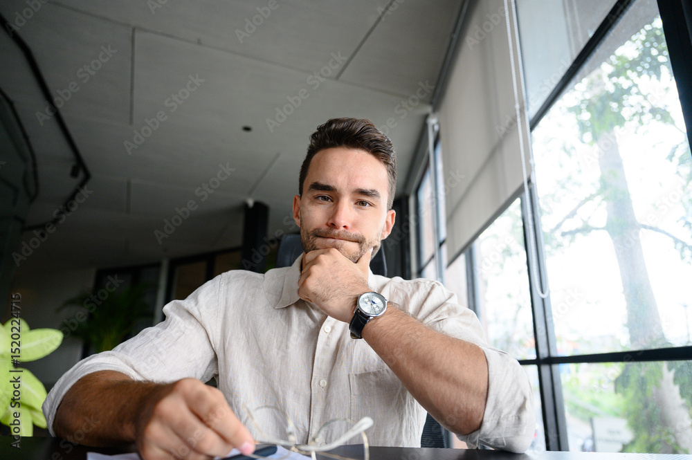 Confident Young Caucasian Male in Modern Office Wearing a Casual White Shirt Confident Young Caucasian Male in Modern Office Wearing a Casual White Shirt