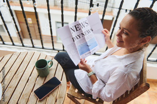 Woman Enjoying Morning Coffee and Newspaper on an Outdoor Terrace