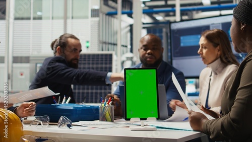 Wallpaper Mural Photovoltaics plant specialists design solar cell prototypes on mockup device. Factory engineers using isolated screen tablet to refine designs for increased energy output using data, camera A Torontodigital.ca