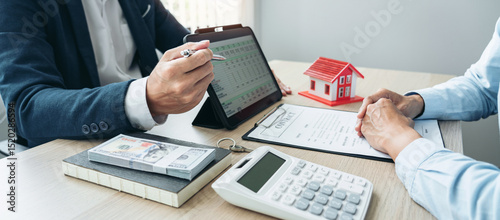 Real estate broker agent consulting the customer to a decision making sign insurance form agreement contract