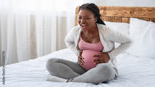 Photos Pregnant black lady having labor contractions at home, suffering from acute bell