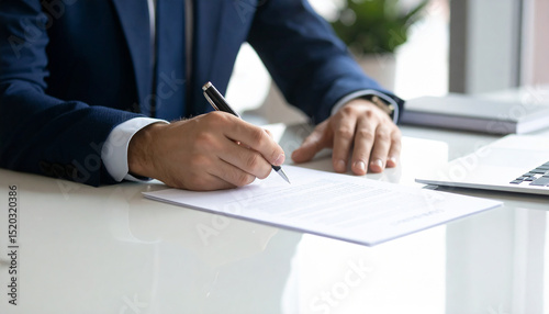 Businessman signing a contract with a pen on a white desk