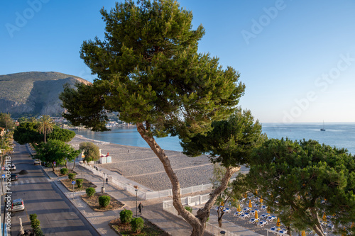 Fototapeta Naklejka Na Ścianę i Meble -  Sunny day on seaside vacation destination, Mondello Beach, near Palermo in Sicily with fine, golden sand, turquoise waters and charming villas, South of Italy