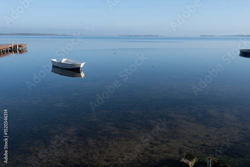 Morning stillness and mirror-quiet water at Stagnone of Marsala, lagoon and nature reserve near Marsala, Sicily, Italy, fisherman's boats