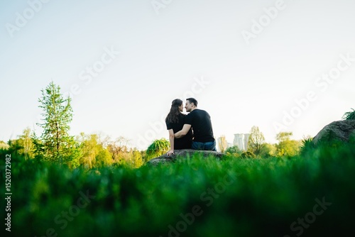Couple enjoys a romantic moment amidst lush greenery in the park
