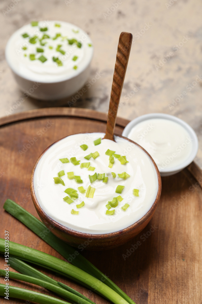 Composition with sour cream and green onion on grunge table