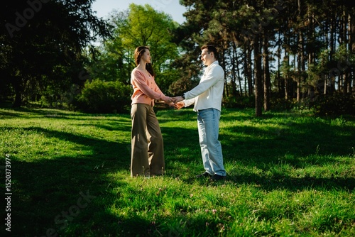 Couple enjoys a romantic moment in a sunlit park during springtime