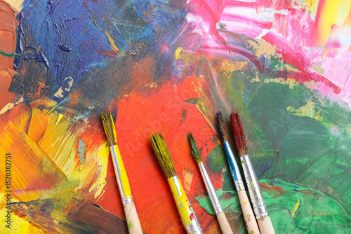 Fototapeta Naklejka Na Ścianę i Meble -  Artist's brushes on paint palette, closeup