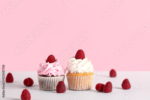 Two raspberry cupcakes with...