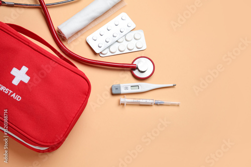 First aid kit and pills on ...