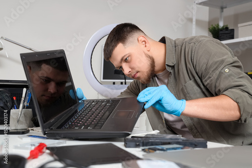 Male technician repairing l...