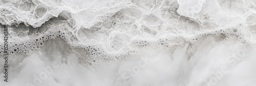 Abstract close-up of frothy, white, grey wave texture