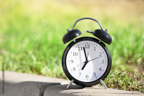 Black alarm clock in park, ...