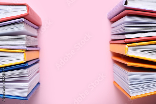Open colorful books on pink...