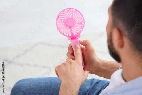 Young man turning on mini f...