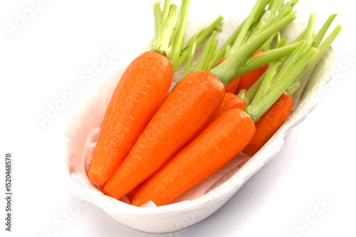 Organic mini carrots isolated on white background.
