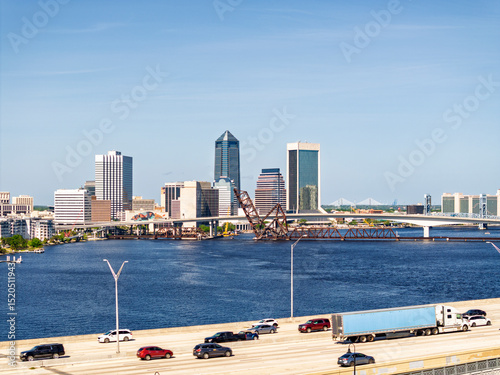 The downtown Jacksonville Florida skyline over the St Johns River with Fuller Warren bridge in foreground.