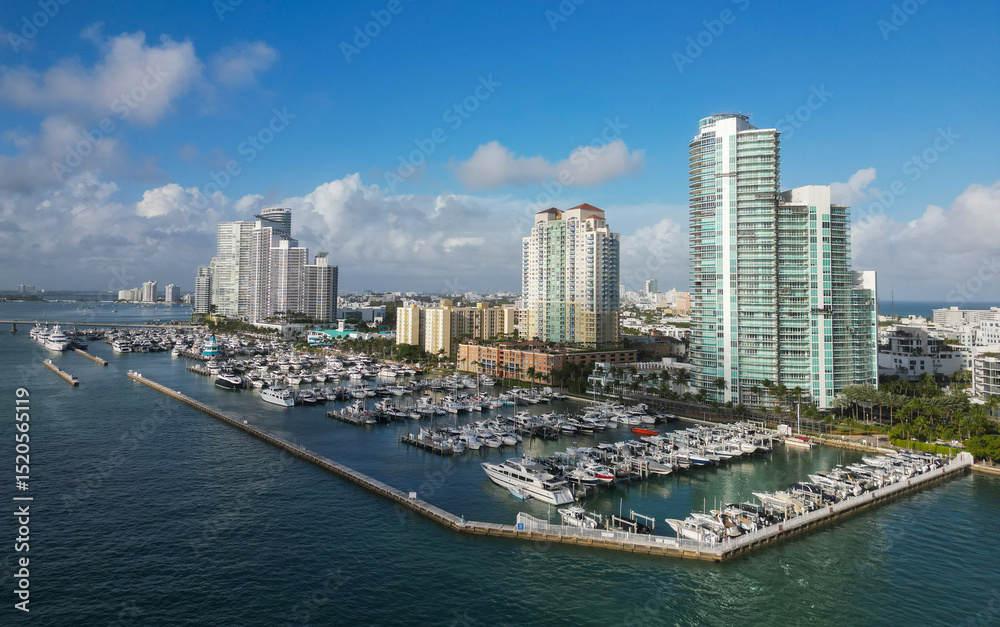 Fototapeta premium Docked yacht in port of Miami. Marina luxury cityscape. Port with yacht. Yachting marina. Luxury yacht charter. Miami port marina. Luxury yachting in summer. Charming marina