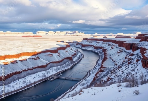 Colorado River meanders through snowy Grand Junction, mesas rise in background,   aerial photography,  winter landscape