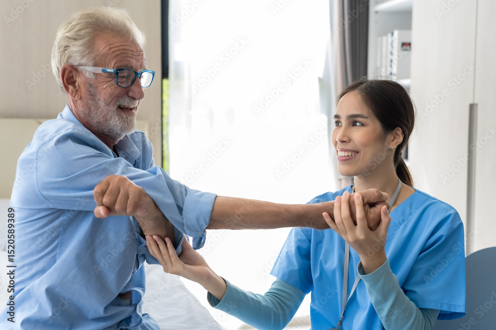 Fototapeta premium Female caregiver helping elderly Caucasian man doing exercise in senior home care