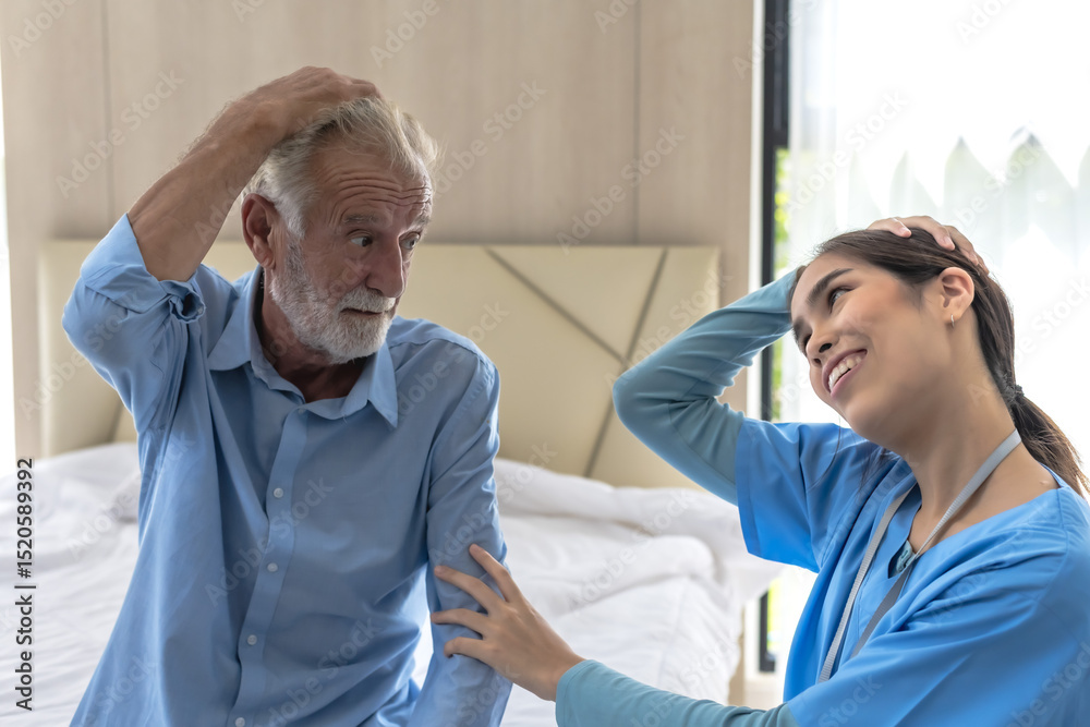 Obraz premium Female caregiver helping elderly Caucasian man exercise in senior home care