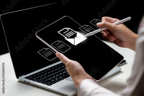 Businesswoman using a tablet with an invoice and mail icon. Laptop on the table. Technology innovation on a virtual screen. Concept of E-invoice and online digital statements
