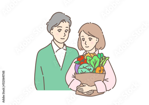 野菜を抱える素敵な若い女性と寄り添う男性。夫婦・カップルの日常風景。
