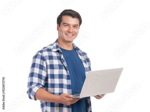 Handsome young man smiling while holding laptop computer, wearing blue checkered shirt, isolated on a transparent background, casual freelancer or student working online, remote work lifestyle concept