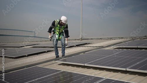 Wallpaper Mural Blue collar worker is inspecting solar panel at rooftop of factory. Energy, sustainability. Torontodigital.ca