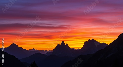 Mountain Peaks Silhouette at Fiery Sunset with Colorful Sky