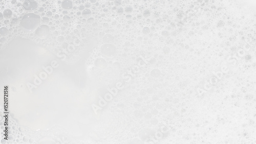 Bubbles create a soft and airy texture in a creamy mixture in a kitchen setting during a sunny afternoon