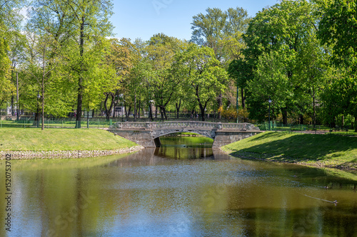 Cast iron pedestrian bridge in the city park.