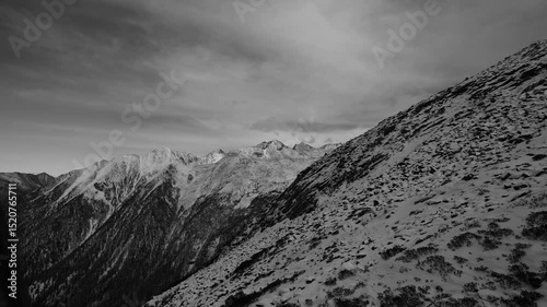 Monochrome, blank and white tone, Snow-covered rock mountain peaks and valley landscape, view from the cable car 