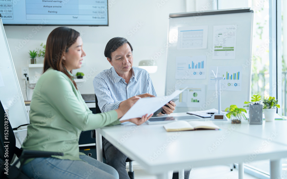 Obraz premium Office group working on green power solution for achieving carbon neutrality in clean energy industry