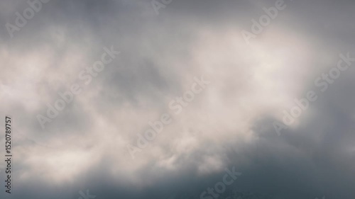 Timelapse or speed movement The atmosphere is gloomy with thick clouds floating and obscuring the mountains behind