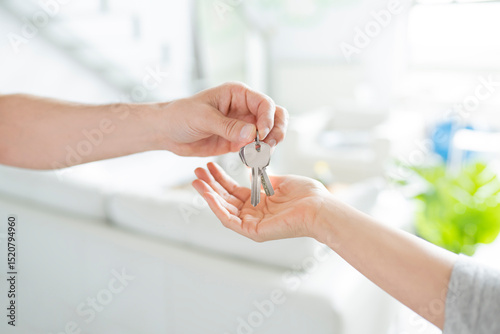 Man giving bunch of keys to woman photo