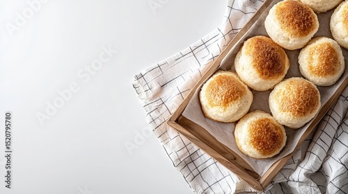 Freshly Baked Soft Bread Rolls in Wooden Tray with Cloth Napkin