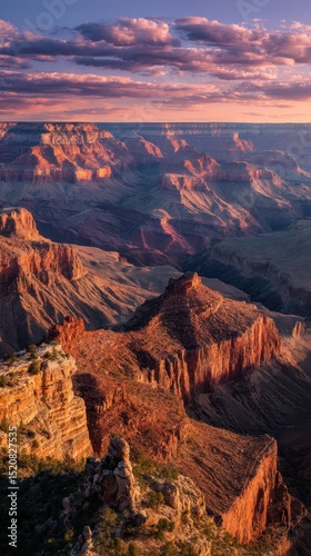 Dawn at Zion Canyon, warm tones lighting steep sandstone walls and casting soft shadows into narrow canyon paths