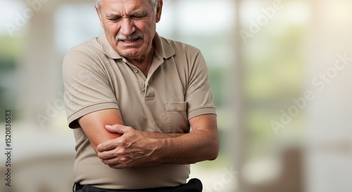 Man Suffering from Elbow Pain Injury Holding Arm